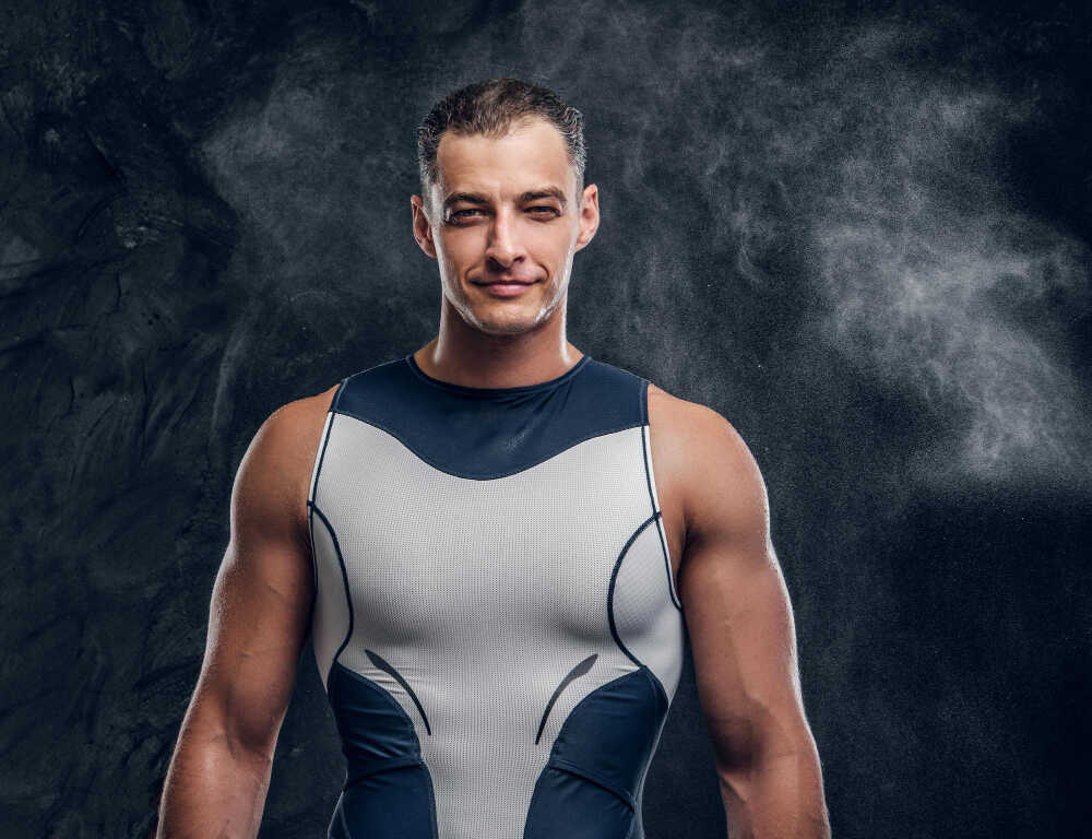 portrait-muscular-handsome-man-wetsuit-with-cloud-talc-around-dark-background
